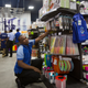 Employees of the supermarket chain Nakumatt stock shelves